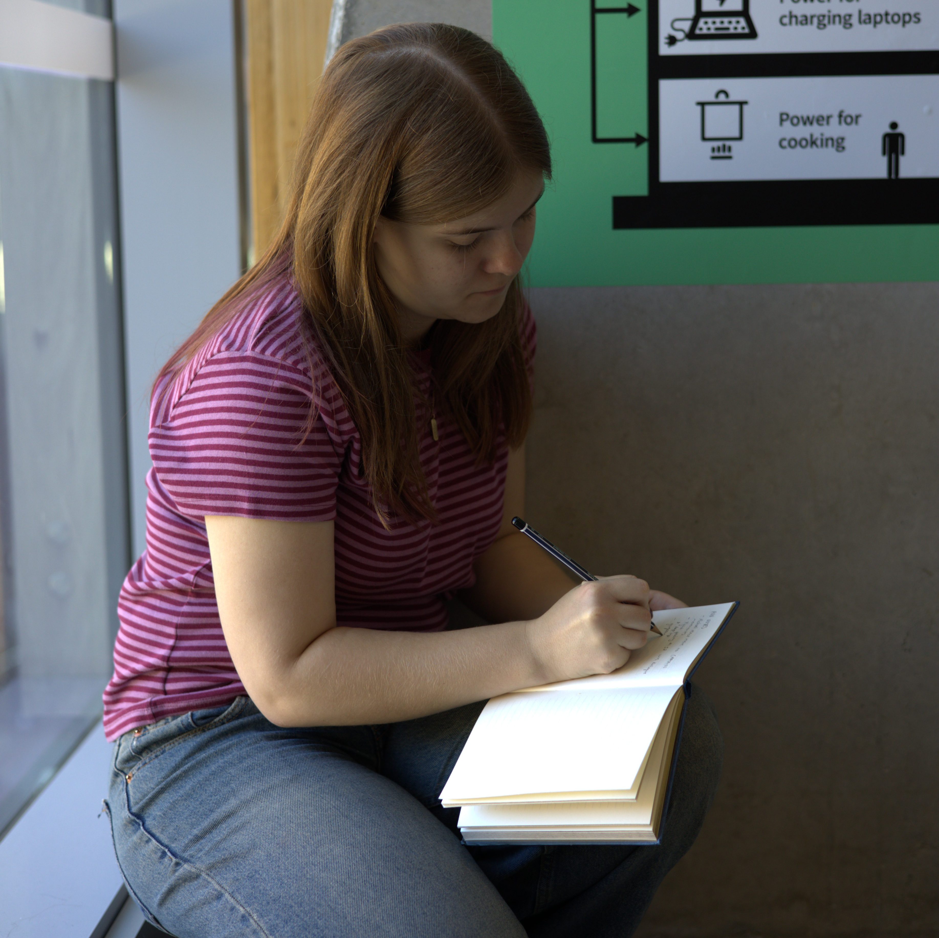 An image of Alana writing notes during a rehearsal.